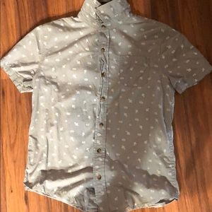 It’s a gray cotton shirt with white designs